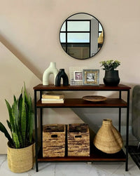 Wooden console table with decorative items in a living room setting