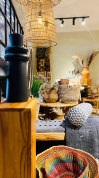 Decorative interior setting with vases, baskets, and a lamp in a room.