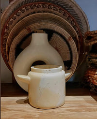 Ceramic lantern with wicker baskets in the background