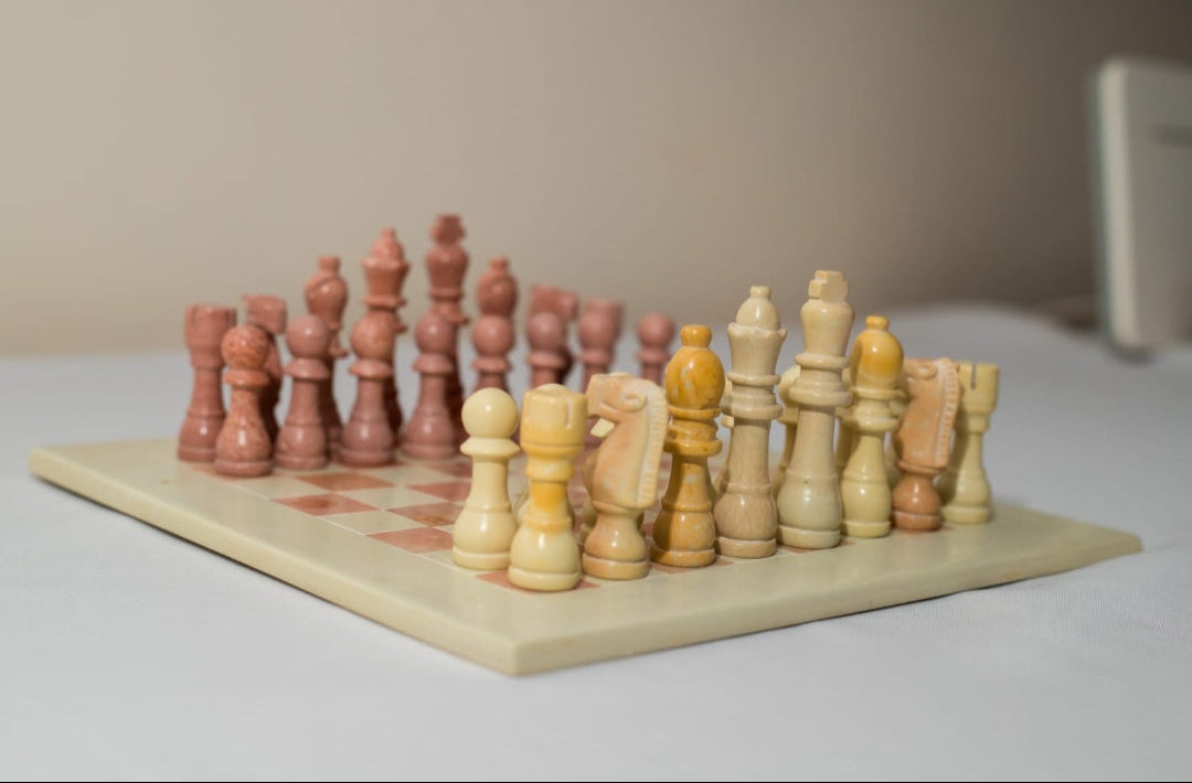 Wooden chess set with pieces on a checkered board