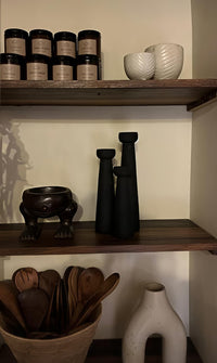 Shelves with decorative items including vases, bowls, and jars.